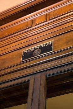 Home Elegant wooden interior featuring the "In God We Trust" plaque, symbolizing American values.